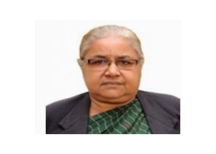 Sushila Karki, wearing glasses and a green patterned blouse, poses for a formal portrait.