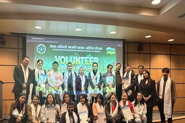Group of individuals posing for a photo at a volunteer appreciation event organized by the Federation of Indigenous Peoples of Nepal America.
